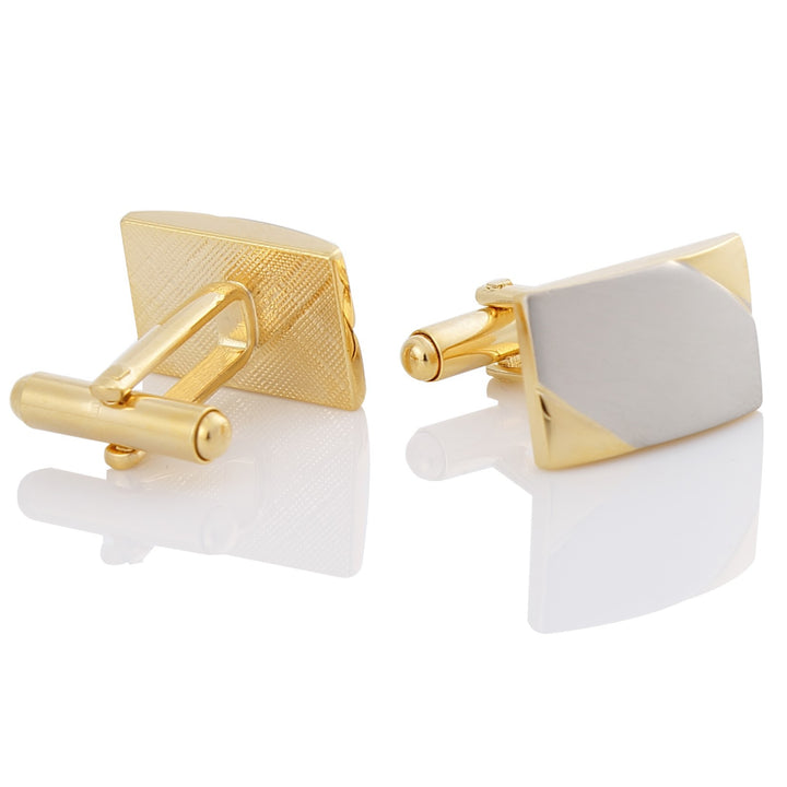 Gold and gray cufflinks on a white background