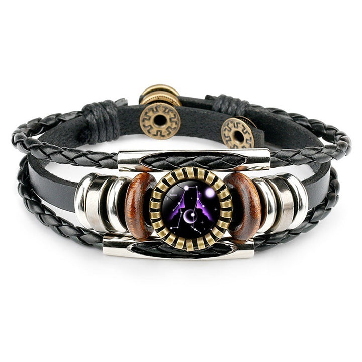 Multistrand leather bracelet with metallic and wooden accents on a white background