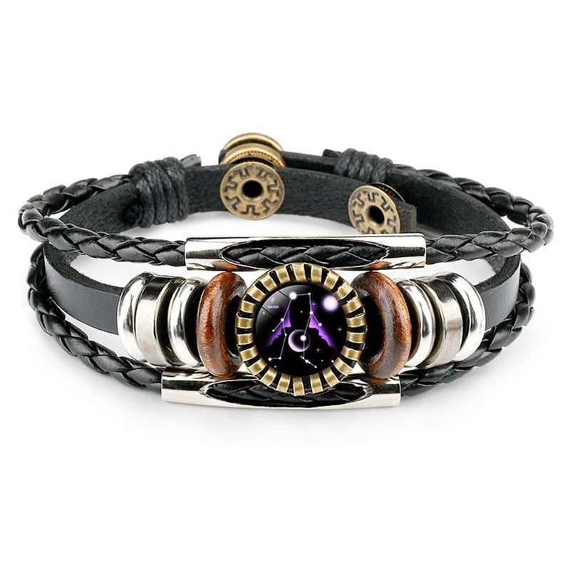 Multistrand leather bracelet with metallic and wooden accents on a white background
