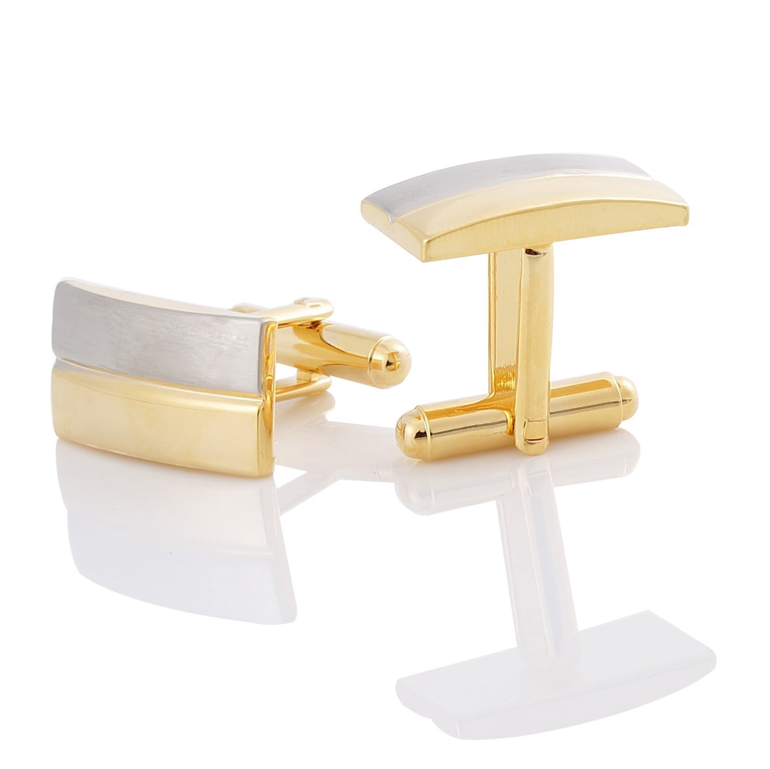 Gold and silver cufflinks on a white background