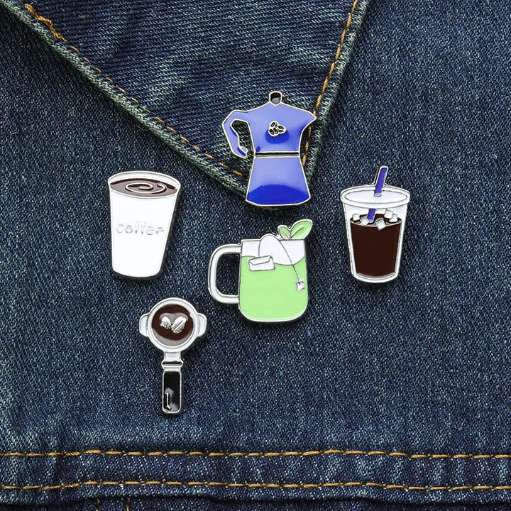 Set of coffee-themed pins on a denim background