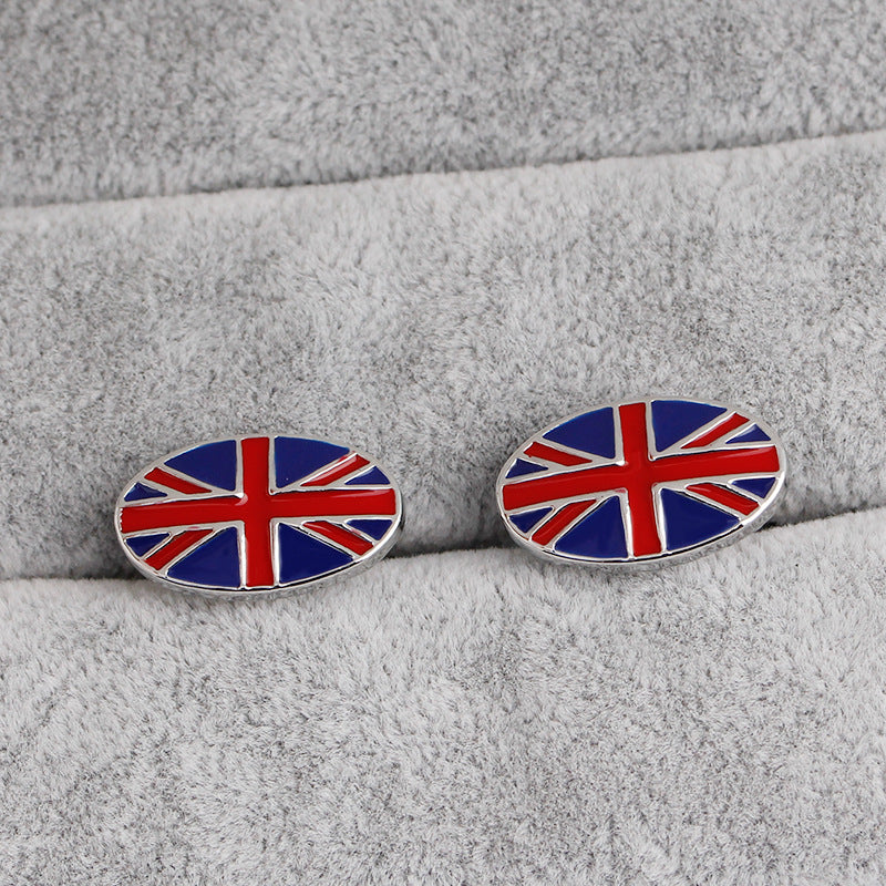 Cufflinks with a Union Jack design on a gray fabric background