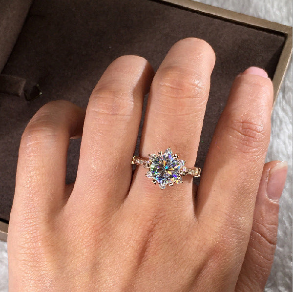 Ring with a colorful gemstone on a hand, set against a neutral background