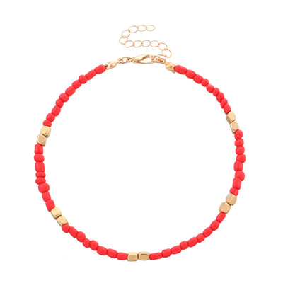 anklet with red and gold beads on a white background