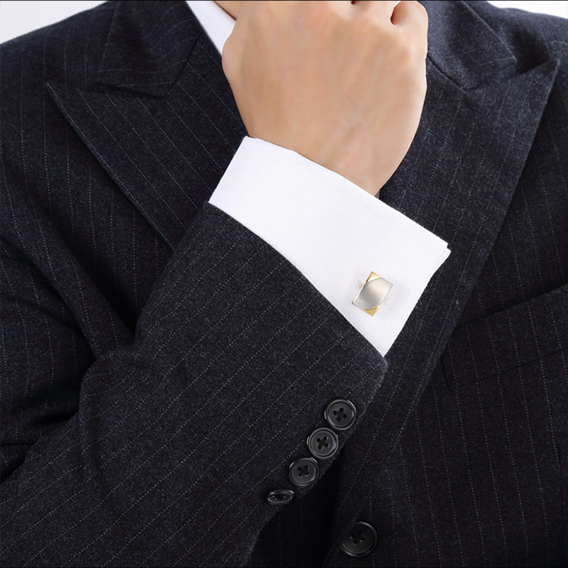 Close-up of a suit cuff with a cufflink on a white background