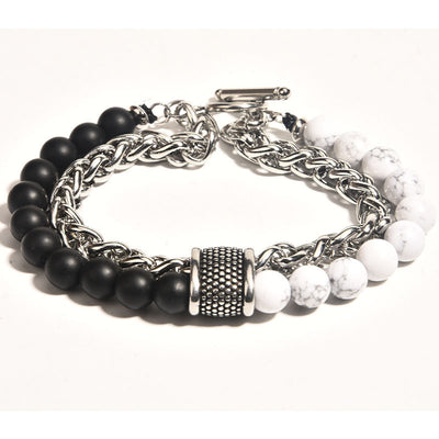 Three bracelets with black beads, silver chain, and white stones on a white background