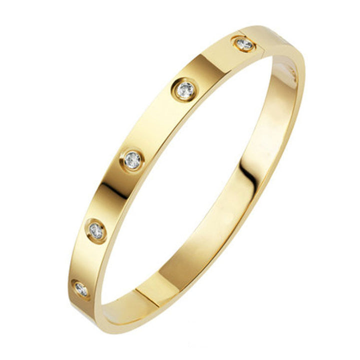 Gold bracelet with small diamonds on a white background