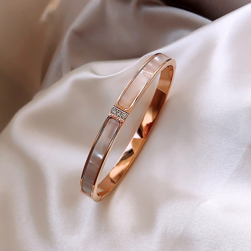 Rose gold bracelet on a soft fabric background