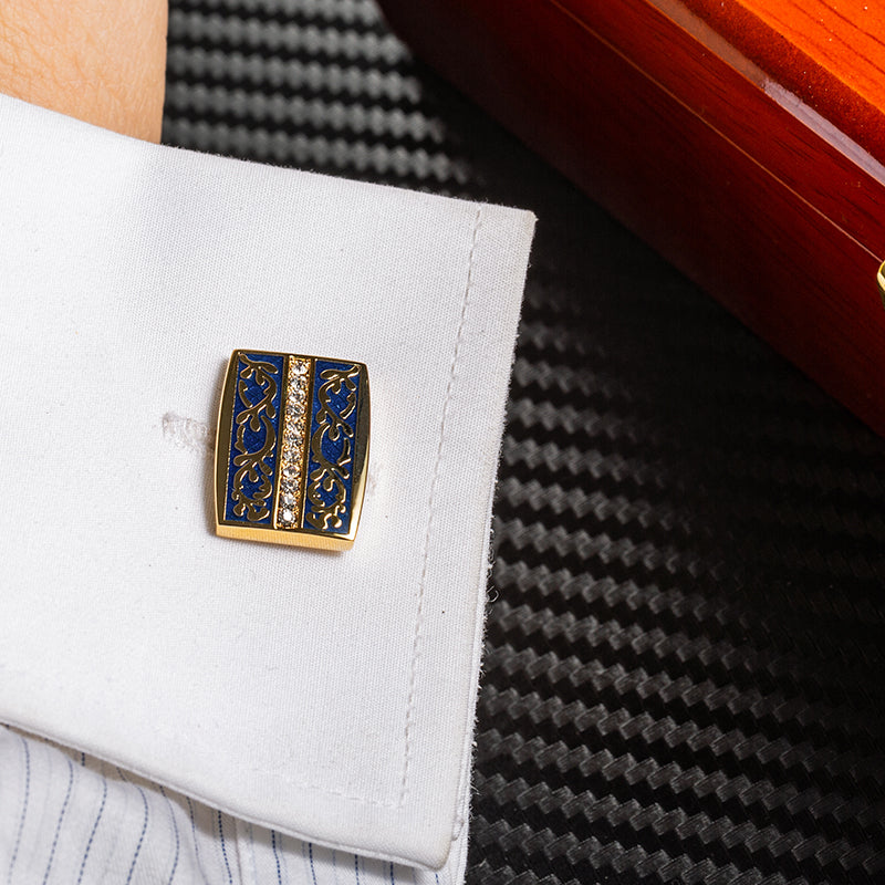 Gold and blue cufflinks on a white shirt 