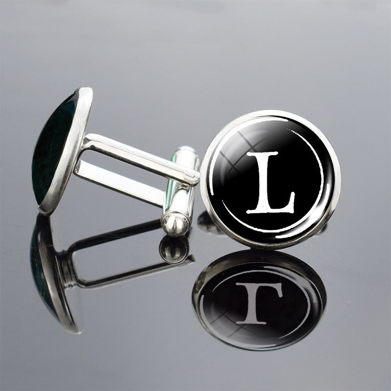 Cufflinks with black round faces featuring white letter &