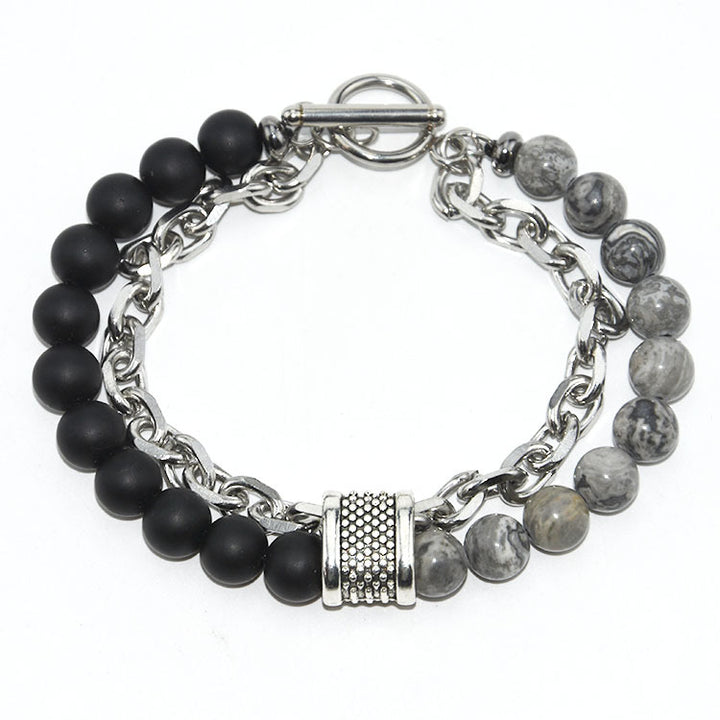 Bracelet with black beads and silver chain on a white background
