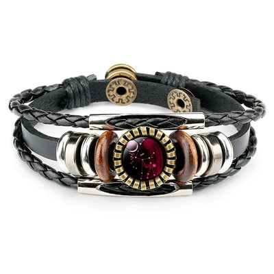 Braided leather bracelet with metallic and wooden accents, featuring a central red circular charm. Stylish, earthy, and slightly rustic design.