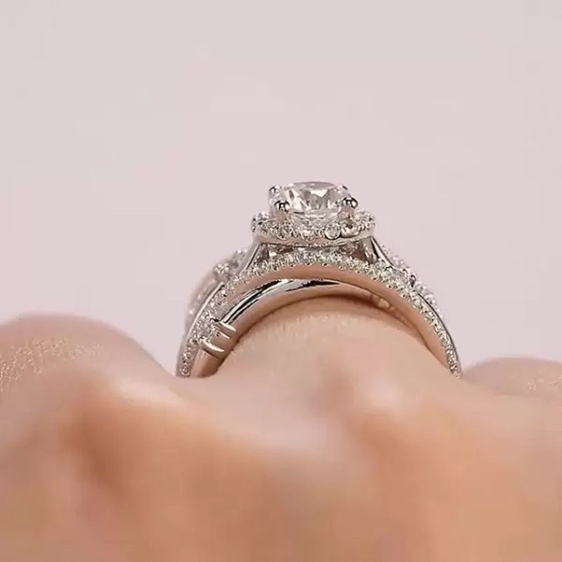 zircon ring on a finger with a soft pink background