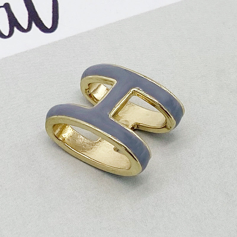 Gold and gray ring on a light gray background