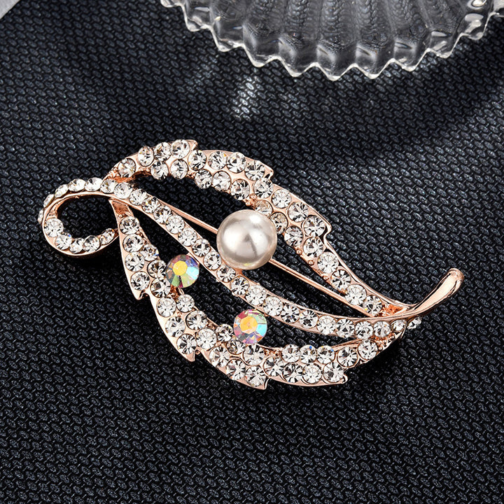 Decorative brooch with pearl and crystals on a black textured background