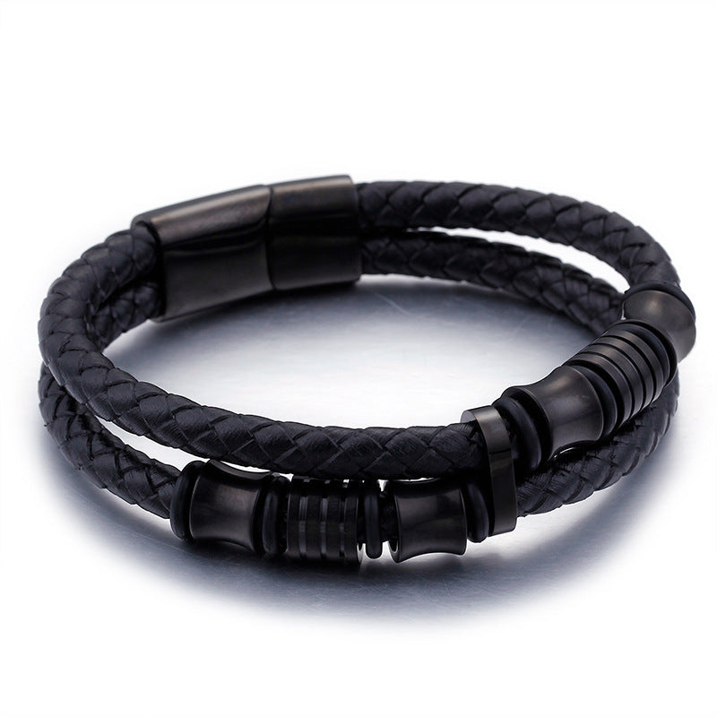 Black braided leather bracelet with black metal accents on a white background