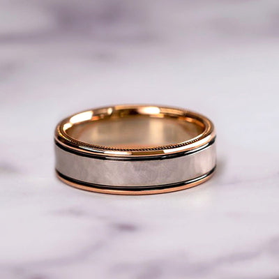 rose gold wedding bands on a marble surface