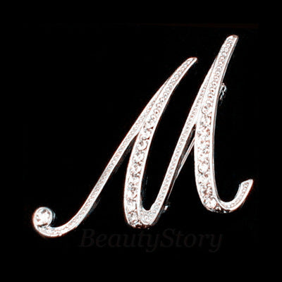 Silver brooch with the letter &