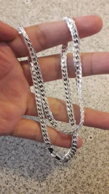 a man holding 925 sterling silver chain
