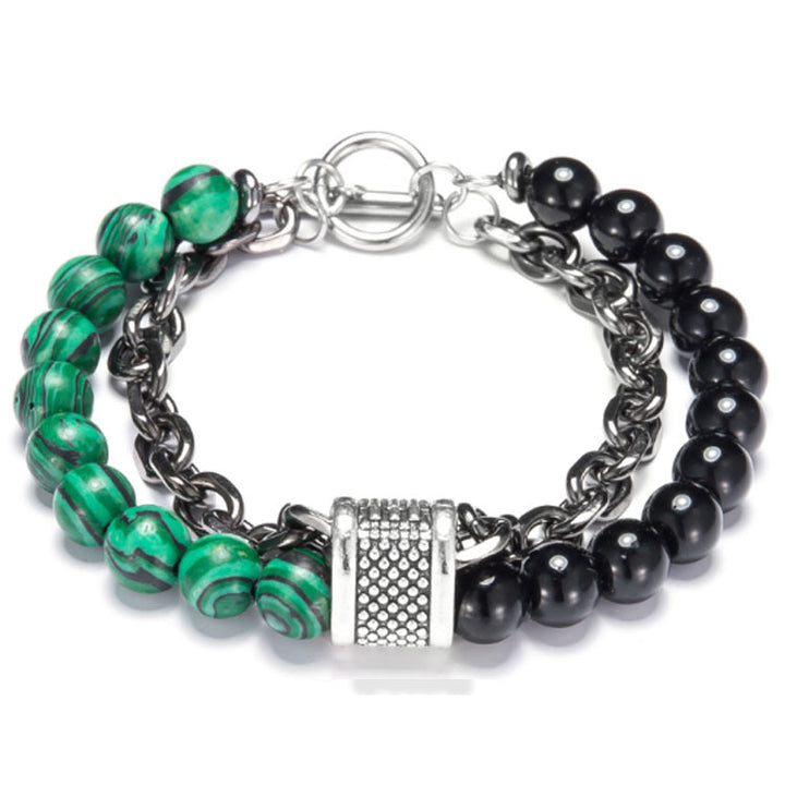 Bracelet with green and black beads and a silver clasp on a white background