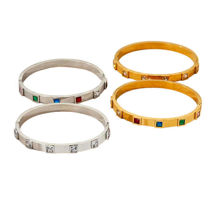 Set of three bracelets in silver, gold, and yellow with gemstone accents on a white background