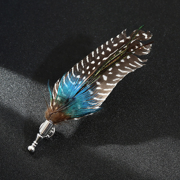 Feathered brooch with blue and brown colors on a black background