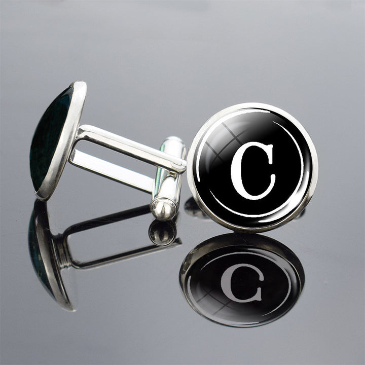 Cufflinks with black round buttons featuring the letter &