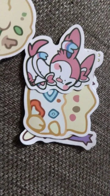 Cartoon character sticker with colorful design on a textured surface