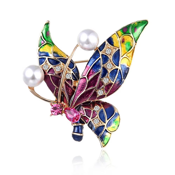 Multicolored butterfly brooch with pearls and gemstones on a white background