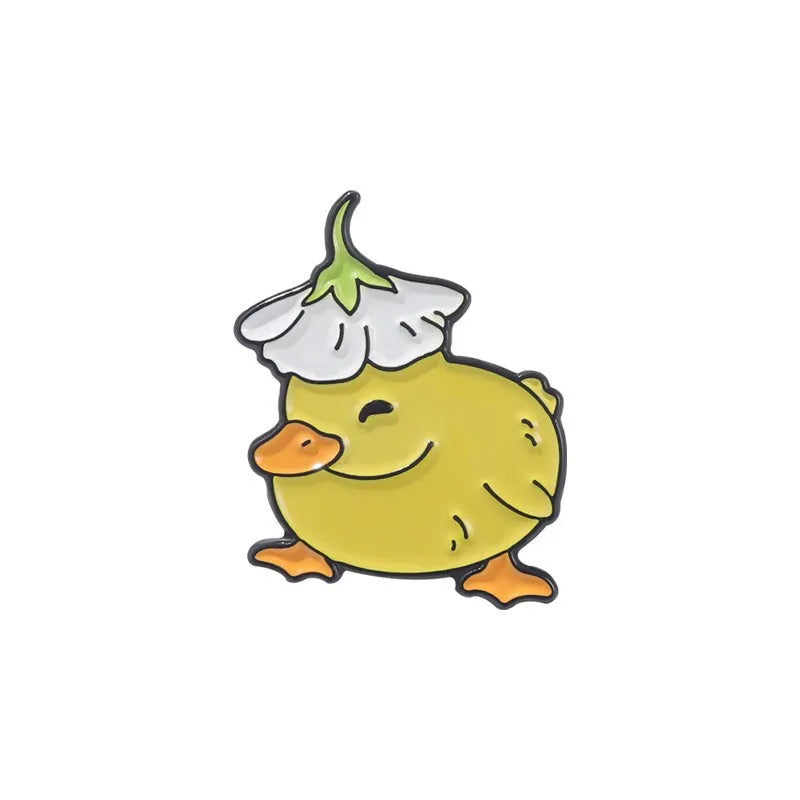 Cartoon-style yellow chick enamel pin with a white flower on its head against a white background