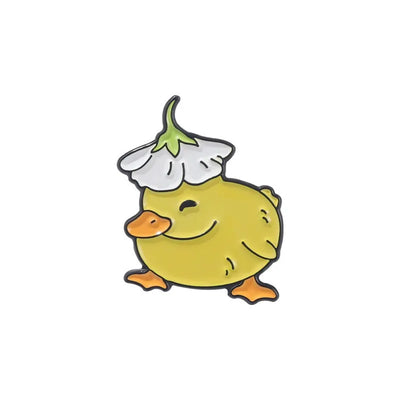 Cartoon-style yellow chick enamel pin with a white flower on its head against a white background