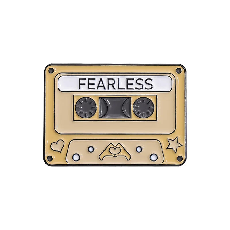 Cassette tape-shaped enamel pin  with 'FEARLESS' text on a white background