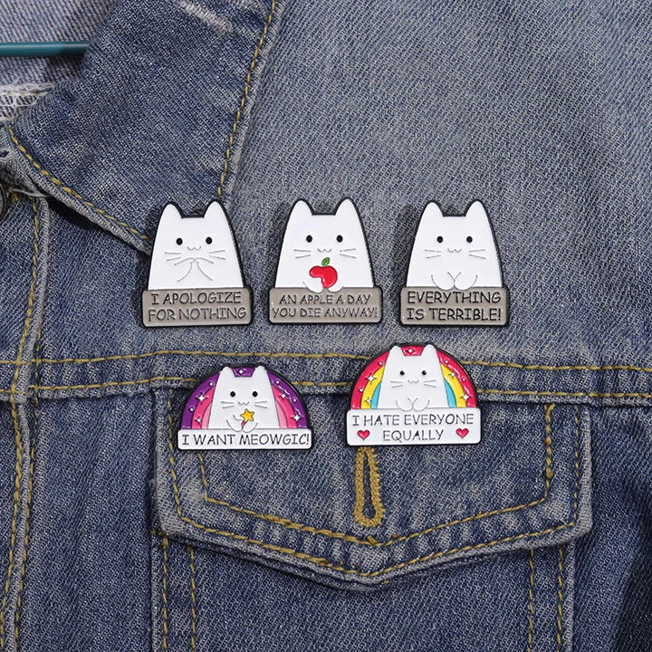 Cat-themed pins on a denim jacket
