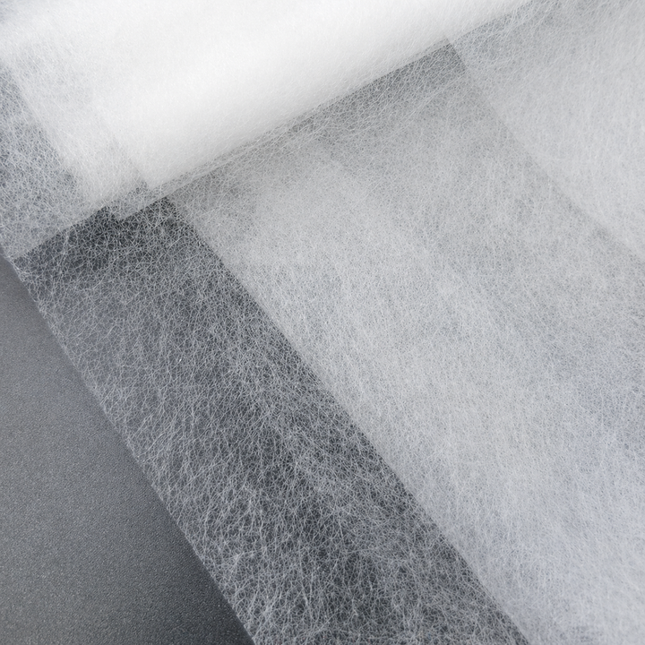 Close-up of white Fusible Interlining Fabric with a textured pattern