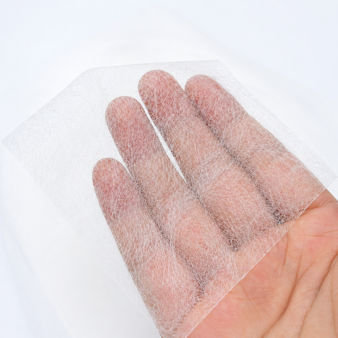 Hand holding a piece of Fusible Interlining material 