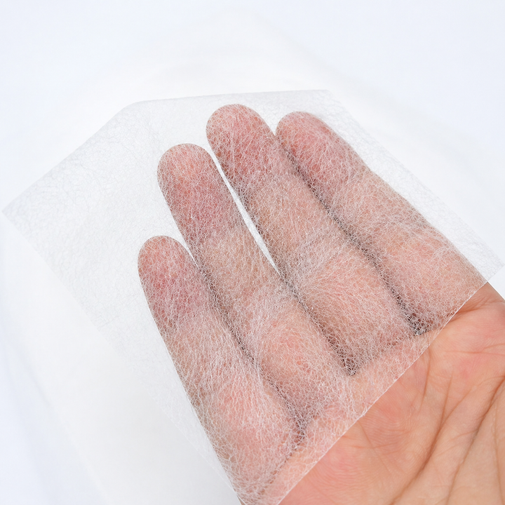 Hand holding a piece of Fusible Interlining material 