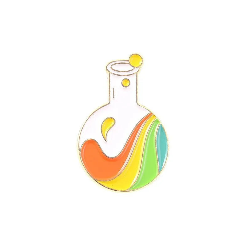 Colorful beaker enamel pin with orange, yellow, and green liquid on a white background