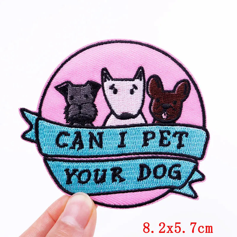 Embroidered patch with cartoon dogs and text 'Can I Pet Your Dog' on a pink background.