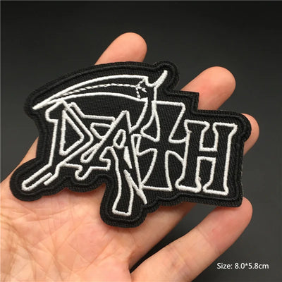 Black and white 'DAVINCHI' patch held in a hand with a dark background
