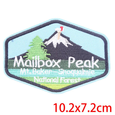 Embroidered patch of Mailbox Peak with mountain and trees design, size 10.2x7.2cm.