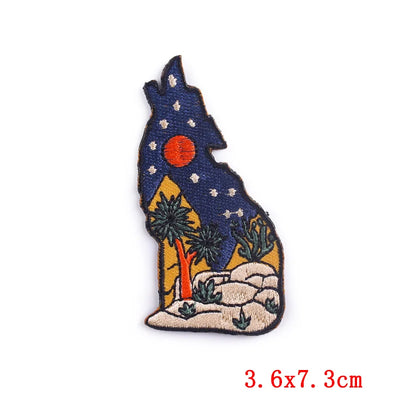 Embroidered patch of a wolf silhouette with a starry sky and moon on a white background