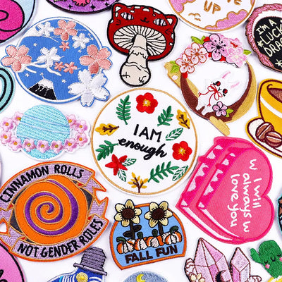 Collection of colorful embroidered patches with various designs and text.