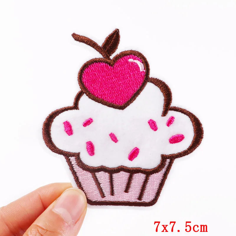 Cupcake-shaped patch with a pink heart on a white background