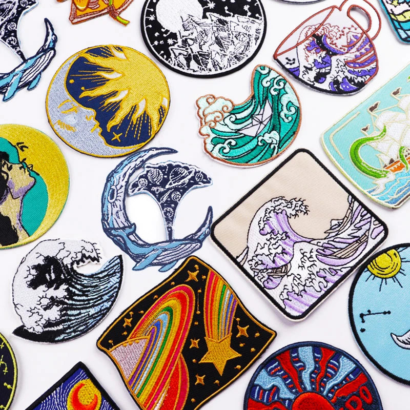 Collection of colorful embroidered patches with various designs on a white background