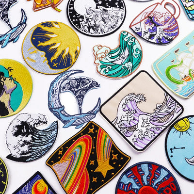 Collection of colorful embroidered patches with various designs on a white background