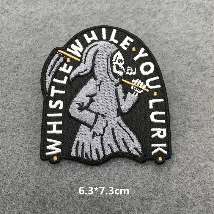 Embroidered patch with skeleton holding a whistle on a gray background