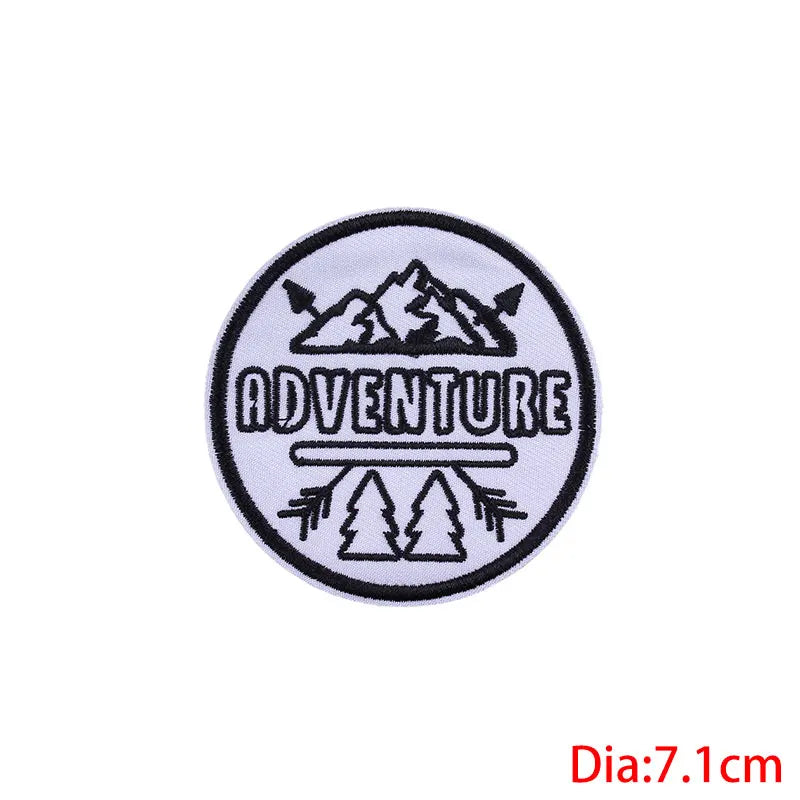 Circular patch with 'ADVENTURE' text and mountain design on a white background