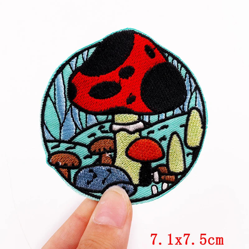 Colorful mushroom patch held by a hand with dimensions displayed