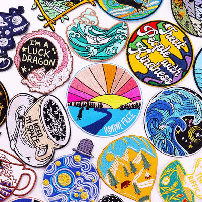 Collection of colorful embroidered patches with various designs on a white background