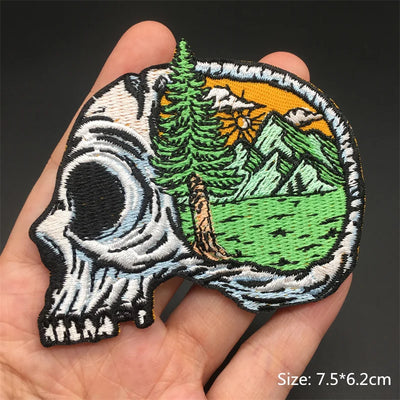 Embroidered patch with skull and nature design held in hand
